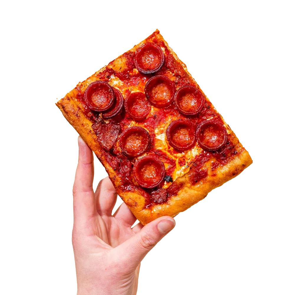 Hand holding a slice of Prince St. Pizza